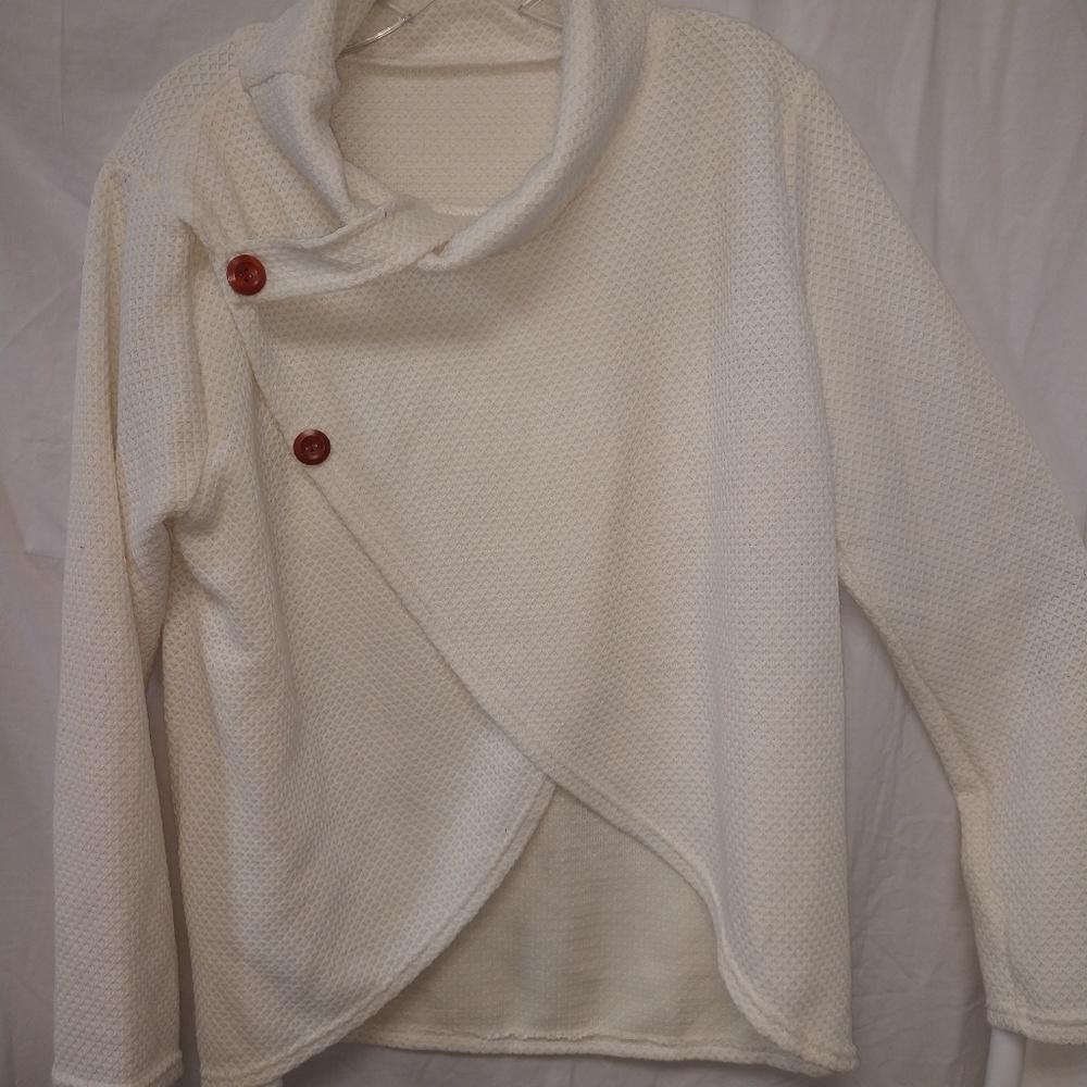 A-symetrical loose neck sweater.